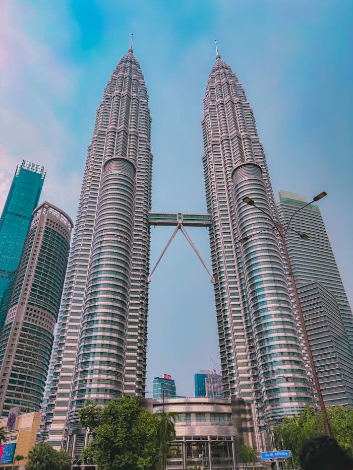Home Dramatic view of the Petronas Twin Towers in Kuala Lumpur under a clear sky.